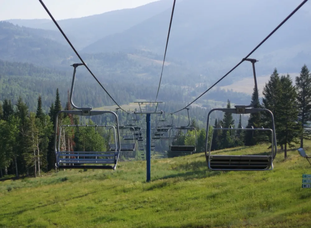 An example of seasonal unemployment depicted in a ski slope in summer, with its ski lifts not in operation.