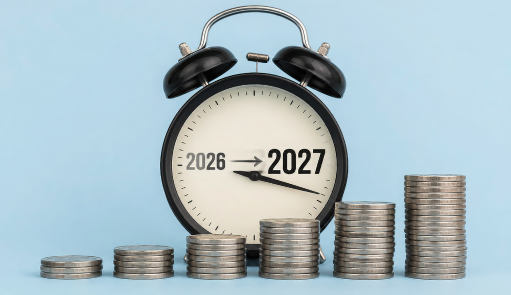 Alarm clock face showing "2026" changing to "2027" behind rising stacks of silver coins