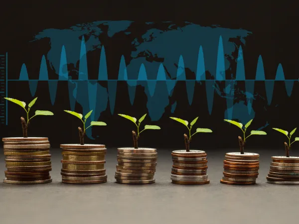 New plants sprout from stacks of coins against a world map and a fluctuating graph, symbolizing growth and investment.