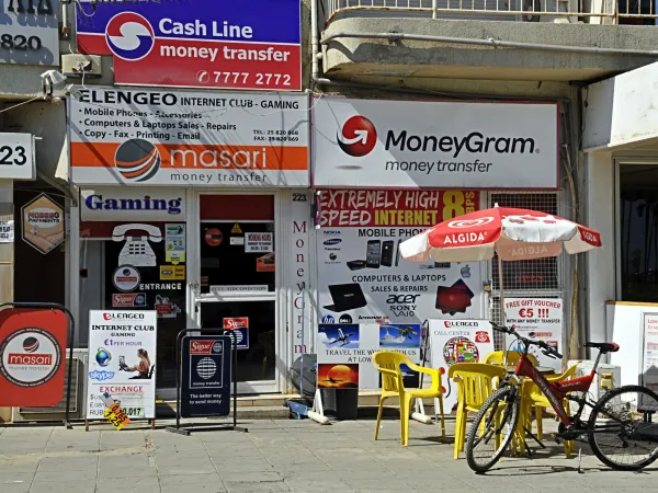  A bicycle parked outside a MoneyGram store, showcasing a typical urban setting.